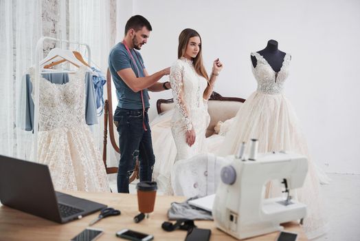 Just a little more movements. The process of fitting the dress in the studio of hand crafted clothes.