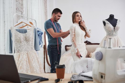 Little help here. The process of fitting the dress in the studio of hand crafted clothes.