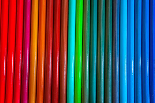 Set of colored pencils in a row. Multicolor background