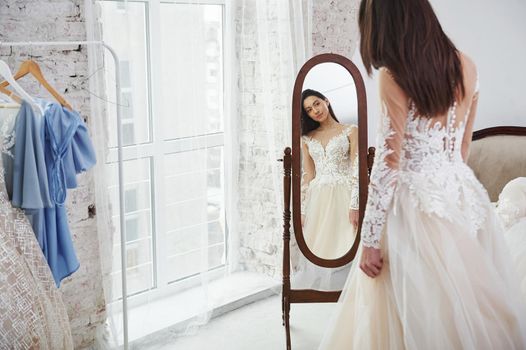 Getting ready for the wedding. The process of fitting the dress in the studio of hand crafted clothes.