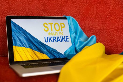 stop war and patriot. laptop, flag of ukraine.