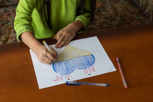 children's drawing, flags of ukraine are drawn on a sheet, children's hands hold a heart made, war between countries, peace concept.