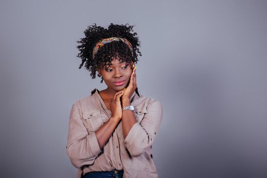 Relaxed and calm. Attractive afro american woman in casual clothes in the studio.