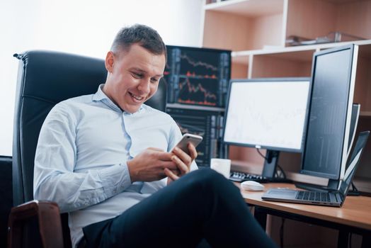 Too many things needed to be successful. Man working online in the office with multiple computer screens in index charts.
