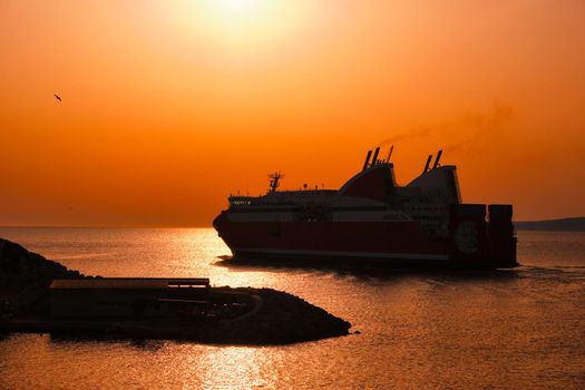 Ferry vessel in sea departing port of Marseille for Corsica on sunset. Marseille, France
