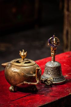 Tibetan Buddhist still life - vajra, bell and water vessel. Hemis gompa, Ladakh, India.