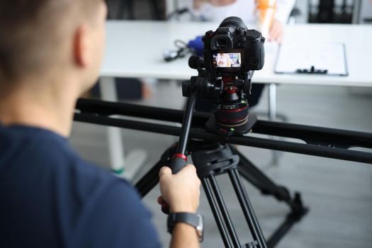 Videographer is filming doctor in clinic. Medical blog and job operator concept