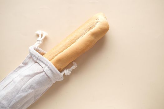 bag with bread on light color background.