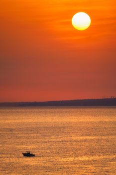 Small fishing boat in sea on sunset. Marseiile, France