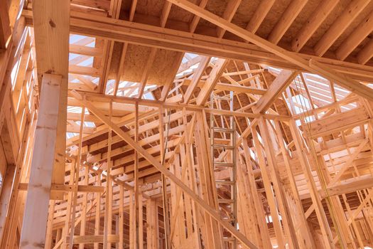 Wooden framing the wall of planks new residential house with construction site