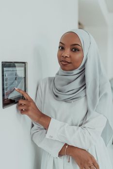 African woman using a smart home screen control system. High-quality photo