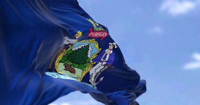 The US state flag of Maine waving in the wind. Maine is a state in the New England region of the United States. Democracy and independence.