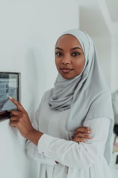 African woman using a smart home screen control system. High-quality photo