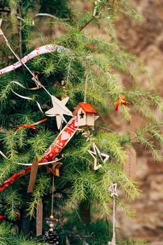 Christmas tree decorated with wooden toys on the branches. High quality photo