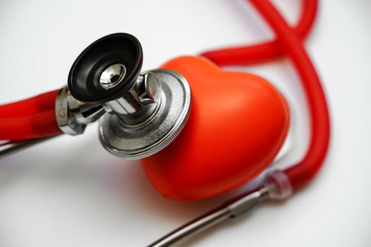 Stethoscope and red heart on white background, heart health, health insurance concept.