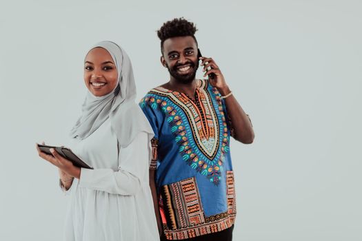 Young African business team woman wearing traditional Sudan Muslim hijab clothes using tablet computer isolated on white background students couple. High-quality photo