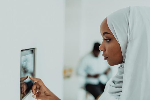 African woman using a smart home screen control system. High-quality photo