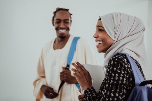 Group of happy African students having a conversation and team meeting working together on homework girls wearing traditional Sudan Muslim hijab fashion. High-quality photo