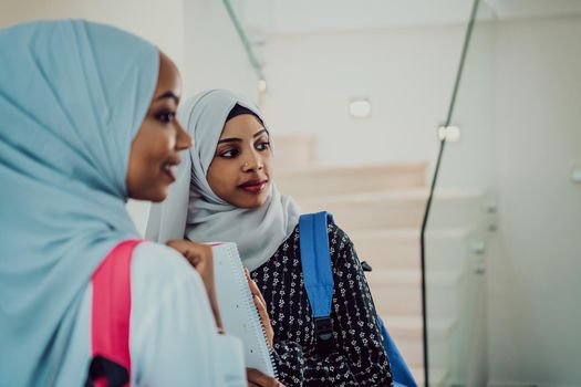 A photo of two african muslim female students with a backpack on their backs in a modern house. High quality photo