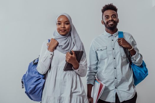 Young African students couple walking woman wearing traditional Sudan Muslim hijab clothes business team isolated on white background.