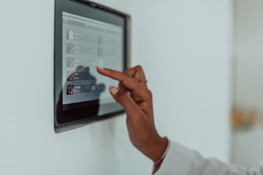 African woman using a smart home screen control system. High-quality photo