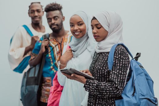 photo of a group of happy African students talking and meeting together working on homework girls wearing traditional Sudanese Muslim hijab. High-quality photo