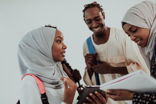 Group of happy African students having a conversation and team meeting working together on homework girls wearing traditional Sudan Muslim hijab fashion. High-quality photo