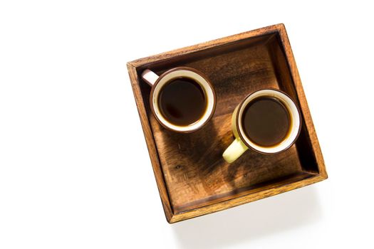 Mango wood wooden tray with four espresso coffee cups on the white background. Empty space