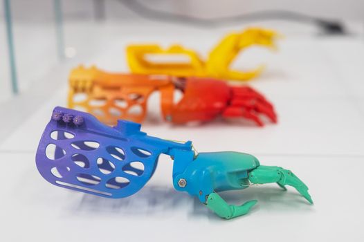 Samples of multi-colored children's prosthetic hands made of 3D plastic