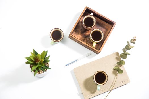 Mango wood wooden tray with four espresso coffee cups on the white background. Empty space