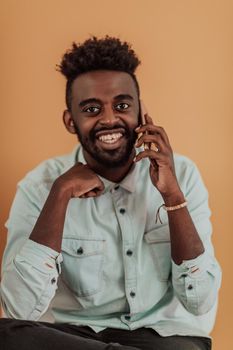 African student using laptop computer to study and make business connections yellow background. High quality photo