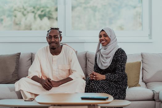 African Muslim couple at home in Ramadan reading Quran holly Islam book. High-quality photo