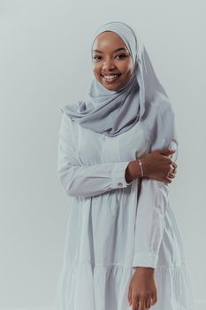 Portrait of young modern Muslim afro beauty wearing traditional Islamic clothes on white background. Selective focus. High-quality photo