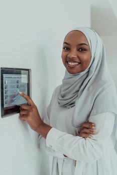 African woman using a smart home screen control system. High-quality photo