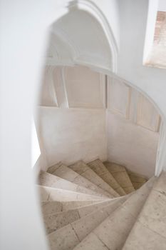 White spiral staircase leading to the first floor of the church