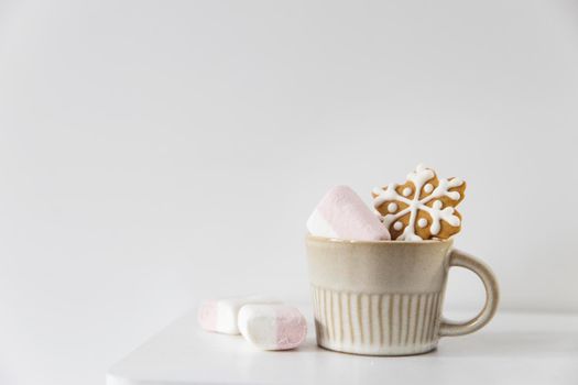 Christmas or New Year composition with cocoa, gingerbread cookies and christmas decorations. Hot chocolate with marshmallows on a white background of table. Copy space. Mock up