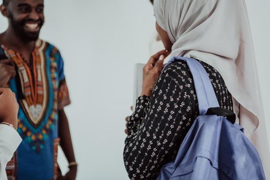 Group of happy African students having a conversation and team meeting working together on homework girls wearing traditional Sudan Muslim hijab fashion. High-quality photo