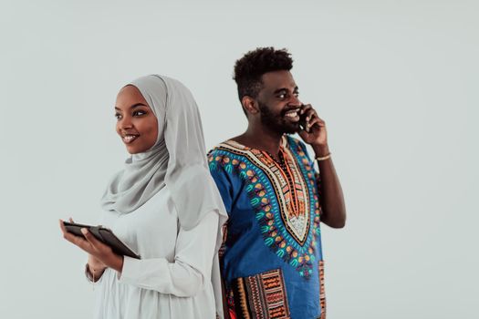 Young African business team woman wearing traditional Sudan Muslim hijab clothes using tablet computer isolated on white background students couple. High-quality photo