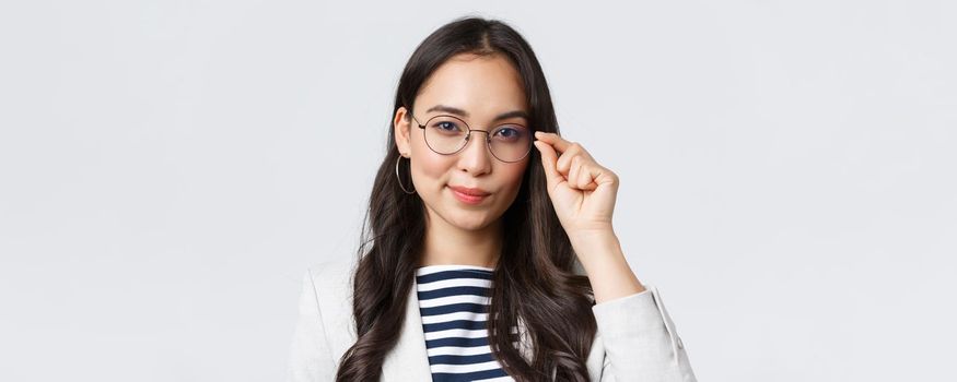 Business, finance and employment, female successful entrepreneurs concept. Close-up of confident young asian businesswoman fixing glasses and looking determined, ready to sign deal.