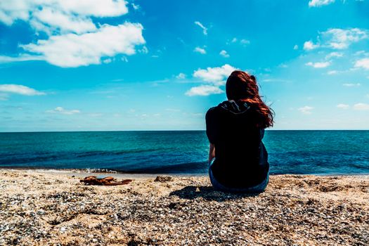 Young fashion woman relax on the beach. Happy island lifestyle. White sand, blue cloudy sky and crystal sea of tropical beach. Vacation at Paradise. Ocean beach relax, travel to Maldives islands,