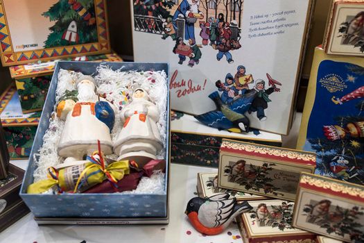 Moscow, Russia - 10 December 2021, Toy Santa Claus and Snow Maiden, candy boxes and cookies designed in the style of the Soviet Union are sold at the GUM Department Store