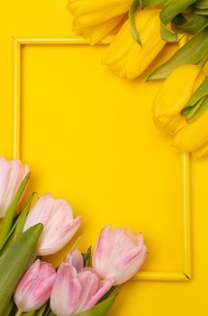 Tulips and a frame on a yellow background . Tulips of kopi space. Yellow background. Mockup . Space for text. A greeting card. Tulips on a yellow background. Spring flowers. March eighth. Mother's Day. Birthday