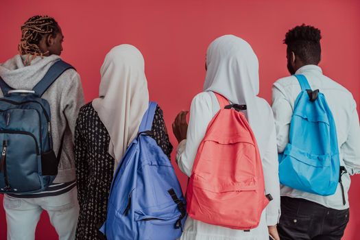 A group of African Muslim students with backpacks posing on a pink background. the concept of school education. High-quality photo