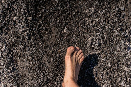 Men's feet with blue socks and campfire rests. Hiking, campground concept.