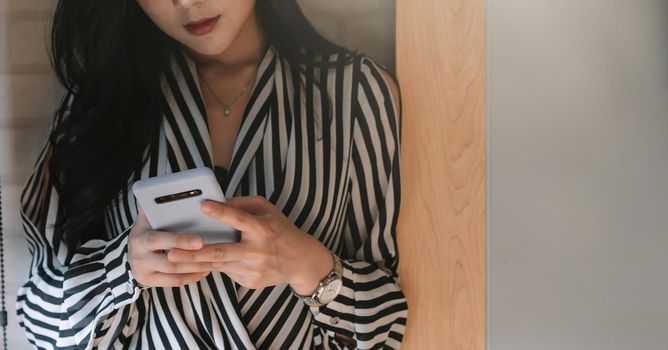 Business asian woman using smartphone at office.