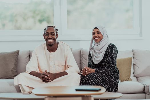 African Muslim couple at home in Ramadan reading Quran holly Islam book. High-quality photo