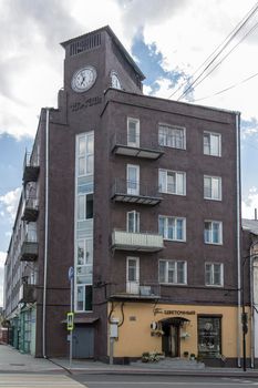 Serpukhov, Russia - June 18, 2021: The building with a clock in the historic center of the city on Lenin Square. 1930 year of construction, style of architecture - constructivism