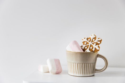 Christmas or New Year composition with cocoa, gingerbread cookies and christmas decorations. Hot chocolate with marshmallows on a white background of table. Copy space. Mock up