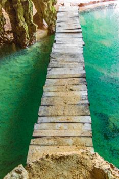 Amazing blue turquoise water and limestone cave sinkhole cenote at Santuario de los guerreros in Puerto Aventuras Quintana Roo Mexico.