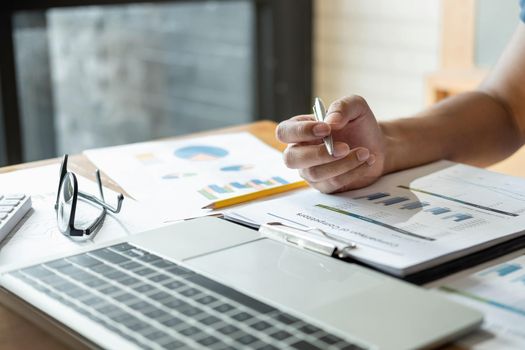 investment adviser analyze and discuss the situation on the financial report in meeting room. Financial, accounting, investment advisor concept.
